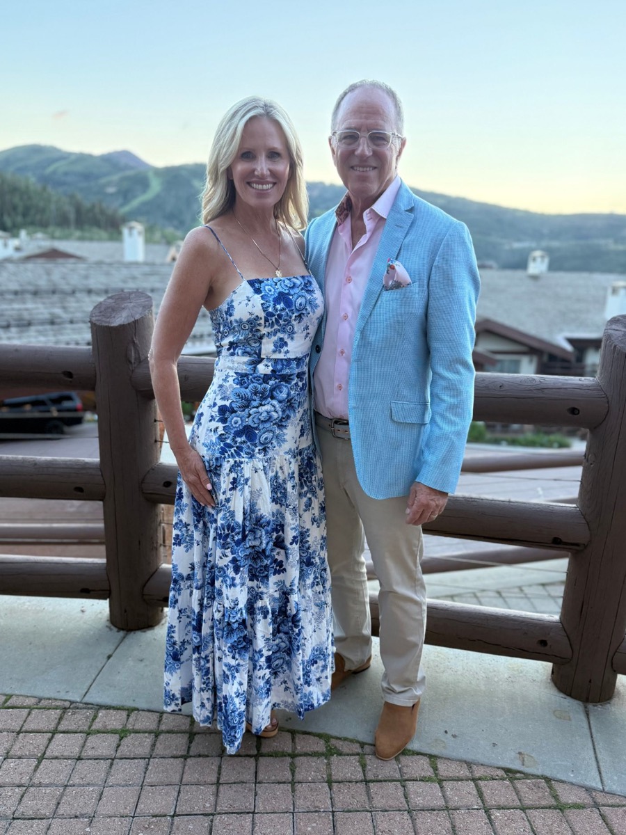 Dr. Juliana Miller and Dr. Robert Miller standing together outdoors with the mountains behind them