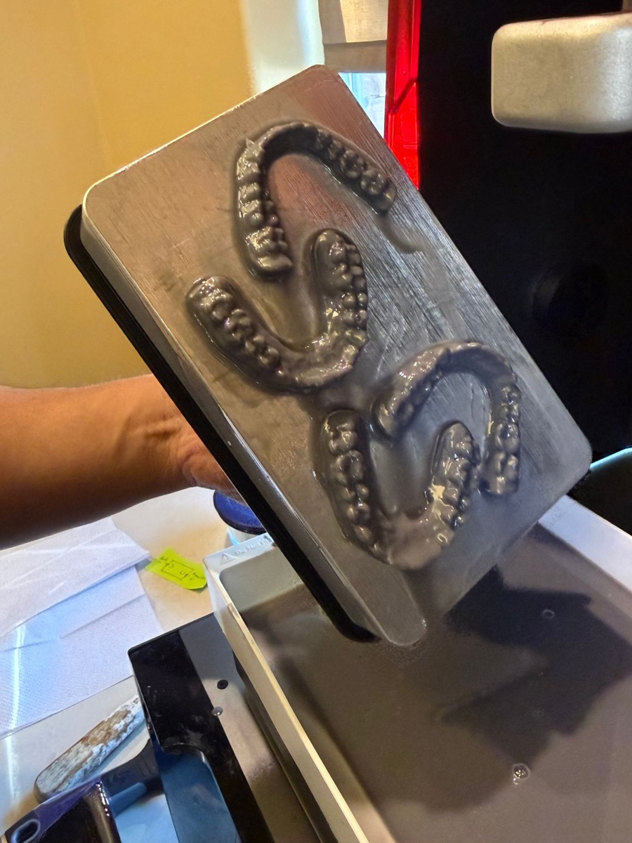 Freshly printed dental models on the SprintRay build plate, lifted out of the resin tray